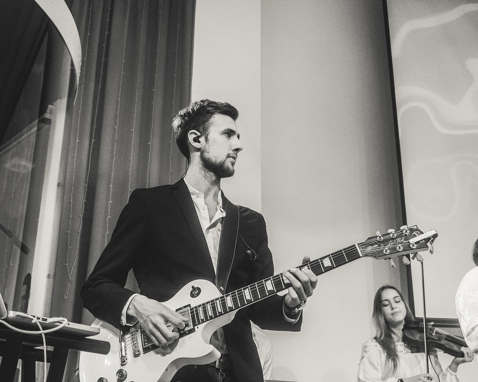 Roman playing guitar in black and white
